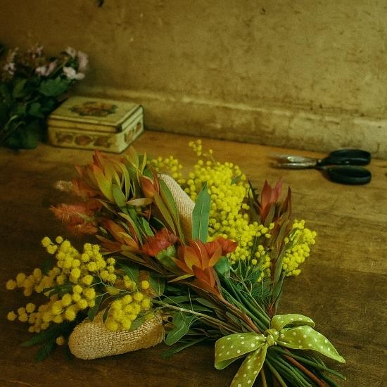 A beautiful native flower arrangement ready for delivery, showcasing a spring bouquet of golden wattle and banksia for a Bathurst gift.