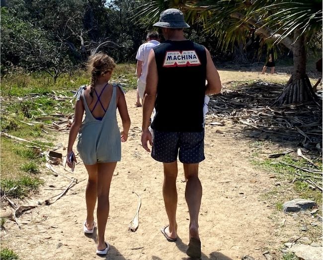Andrew Thomson and his daughter Ivy walking back from cliff jumping at the Angourie Blue Pools