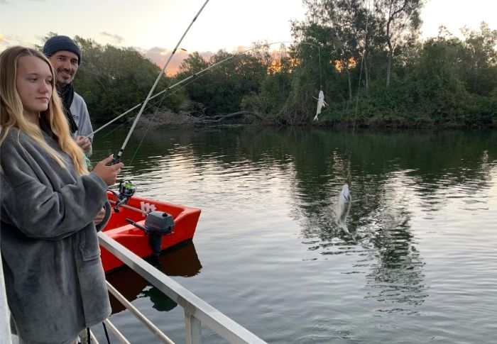 Andrew and Asha fishing from the houseboat at Tumbulgum on the Rous River